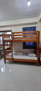 a couple of bunk beds in a room at EJ Cozy Transient in Baguio in Tuba +19 photos