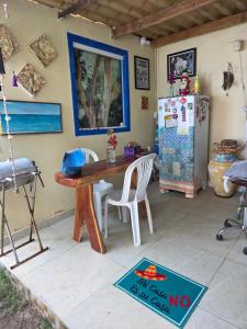 a kitchen with a table and a refrigerator at Flat Lagoa Azul in Maragogi