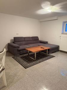a living room with a couch and a coffee table at MainZeit Albertshofen 2 Zimmerwohnung Parkplatz  +6 photos