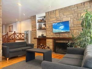 a living room with two couches and a fireplace at Rosa de los Viajes in San Martín de los Andes