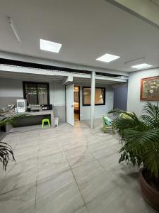 an empty office with a large room with plants at Pridi cozy home with good location Type A in Bangkok