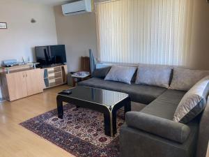 a living room with a couch and a coffee table at Villa Irina in Kŭrdzhali