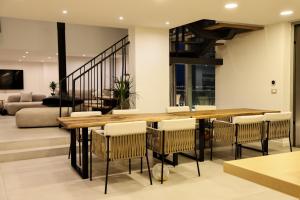 Sky rooftop luxury suites في دوريس: غرفة طعام مع طاولة وكراسي خشبية