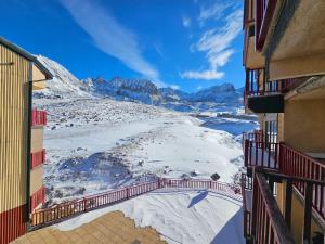 a view of a snowy mountain from between two buildings at Kyra-Apartaments FronteraBL HUT2-6074 in Pas de la Casa