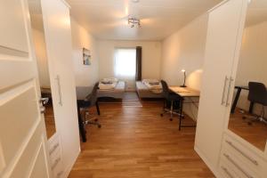 a room with a room with a desk and a room with chairs at Beautiful view, good location, 2 beds, 1 bedroom in Tromsø