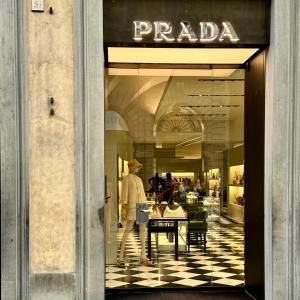 a store window with a person walking into a store at Hotel Cestelli in Florence