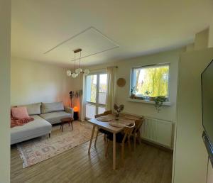 a living room with a couch and a table at Apartament przy Norweskim in Jelenia Góra