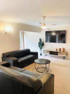 a living room with a couch and a table at LaPoch Guesthouse in Durban +30 photos