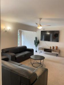 a living room with a couch and a table at LaPoch Guesthouse in Durban