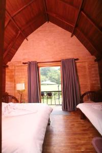 Postel nebo postele na pokoji v ubytování Maggona Boutique Cottages