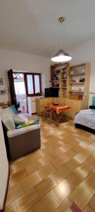 a living room with a couch and a table at Cottage84Milazzo in Milazzo