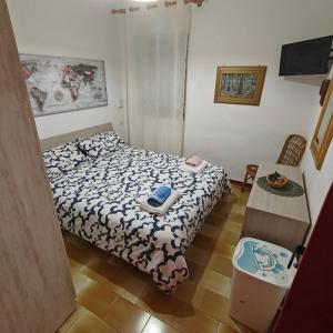 a small bedroom with a bed and a table at Cottage84Milazzo in Milazzo +71 photos