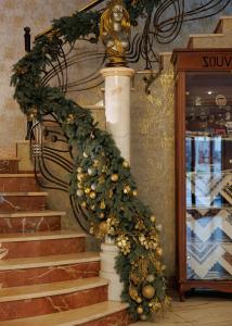a christmas wreath on a staircase in a store at Eurohotel in Lviv +53 photos