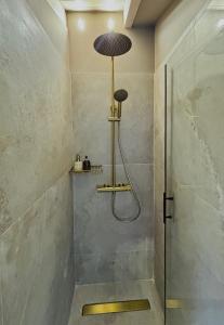 a shower with a glass door in a bathroom at L'Atelier TOP LOCATION in Corfu +15 photos