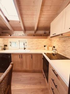 a kitchen with wooden cabinets and a counter top at L'Atelier TOP LOCATION in Corfu