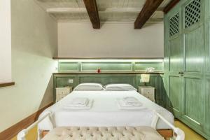 una camera da letto con un letto e una panca di 2 minuti dal Duomo - Parcheggio free a 3 minuti ad Arezzo