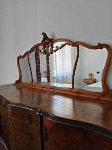 a wooden dresser with a mirror on top of it at Casa Campanella in Spoleto +36 photos