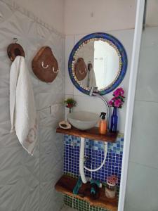 a bathroom with a sink and a mirror on the wall at Flat Lagoa Azul in Maragogi