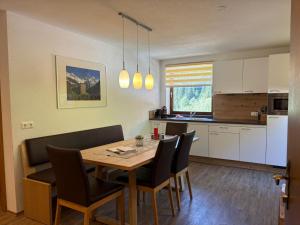 a kitchen and dining room with a table and chairs at Apart Bergland in Kaunertal