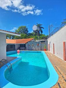 a large blue swimming pool with a water tower at The Corner Hostel in Playa Blanca