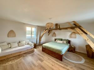 a bedroom with two beds and a couch in it at La Maison du Port Sauvage - Au bord de la Loire in Saint-Clément-des-Levées +35 photos