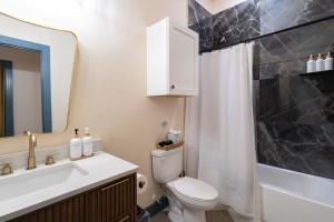 a bathroom with a toilet and a sink and a shower at The Francesca - Apt 334 in Bryan +19 photos
