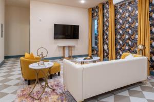 a living room with a couch and a tv at The Francesca - Apt 334 in Bryan