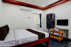 a bedroom with a bed and a tv on the wall at Collection O Chirala Beach View Formerly Sea Shell Resort in Vadarevu +21 photos
