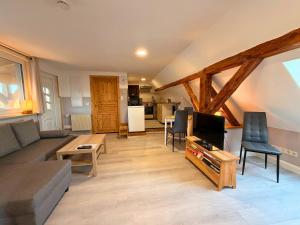 a living room with a couch and a tv at Gasthaus Bomsdorf - ruhige Lage, free WLAN & Parken, Self Check-In, Smart-TV in Bomsdorf