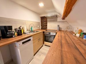 a kitchen with a wooden counter top and a sink at Gasthaus Bomsdorf - ruhige Lage, free WLAN & Parken, Self Check-In, Smart-TV in Bomsdorf