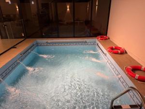 a jacuzzi tub in a room with two redotation devices at albaha harmony resort in Al Baha