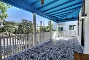 a porch with a blue roof and a fence at Historic French Royal Estate at Capitol, Downtown! in Austin