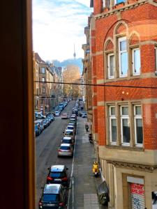 a view of a city street with parked cars at Your home with iconic TV tower views in Stuttgart