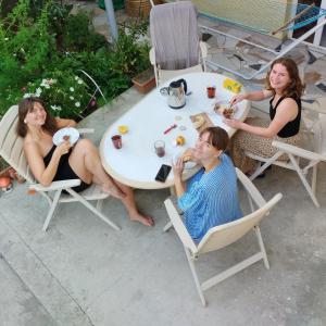 Un grupo de personas sentadas alrededor de una mesa comiendo comida en Why Me Eco-friendly Rooms, en Tiflis 32 fotos más