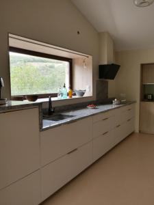 a kitchen with a sink and a window in it at Domaine la Pause in Aveyron in Vabres-lʼAbbaye