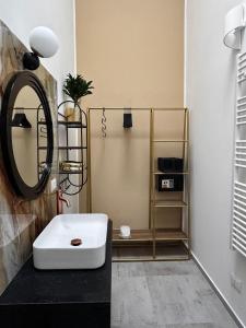 a bathroom with a sink and a mirror at TERA house&rooms in Reggio di Calabria