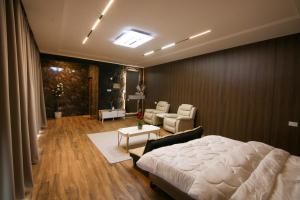 a bedroom with a bed and a living room at كهف الريف Reef Cave in Al Ḩamrāʼ +9 photos