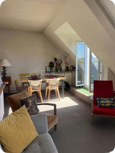 a living room with a couch and a table at 2 bedrooms in the sky ! in Neuilly-sur-Seine