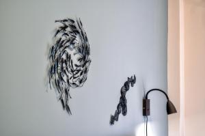 a drawing of a zebra on a wall next to a lamp at Kozimo boutique katoikia in Patra +18 photos