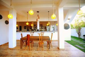 a dining room with a table and chairs at White Lion Paradise Dikwella in Batigama