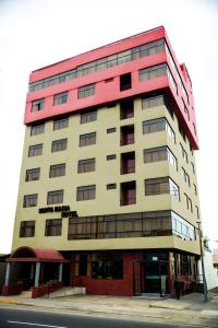 a tall building with a red and white at Hotel Santa Maria in Lima