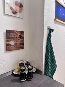 a table with plates and a vase on a wall at Nest76 in Karlsruhe