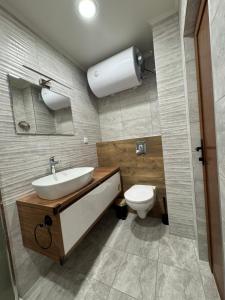 a bathroom with a sink and a toilet at The Golden Spot apart, central with free parking in Yambol +3 photos