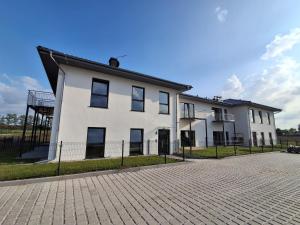 a large white building with a black roof at Apartament Sobieskiego 2, bezpłatny parking in Świebodzin