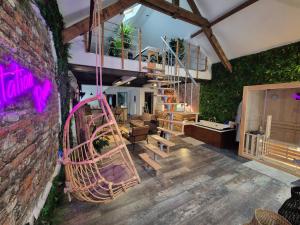 a living room with a spiral staircase and a brick wall at Loft avec Spa Privatif in Frameries
