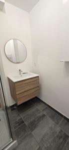a bathroom with a sink and a mirror at Le Charme du Sanctuaire 8 couchages 400m de la Grotte in Lourdes +12 photos
