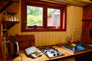 a kitchen with a stove and a sink and a window at Casa de campo in Salto del Laja
