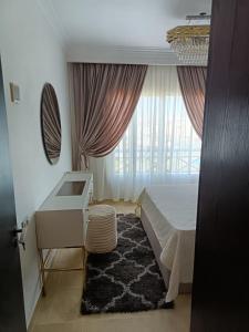 a bedroom with a bed and a sink and a window at ParadiseHotel in Banī Ghālib +30 photos