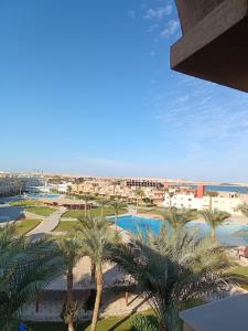 a view of a resort with palm trees and a pool at ParadiseHotel in Banī Ghālib