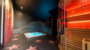 a room with a swimming pool with stars on the floor at Cine47spa in Précy-sur-Oise
